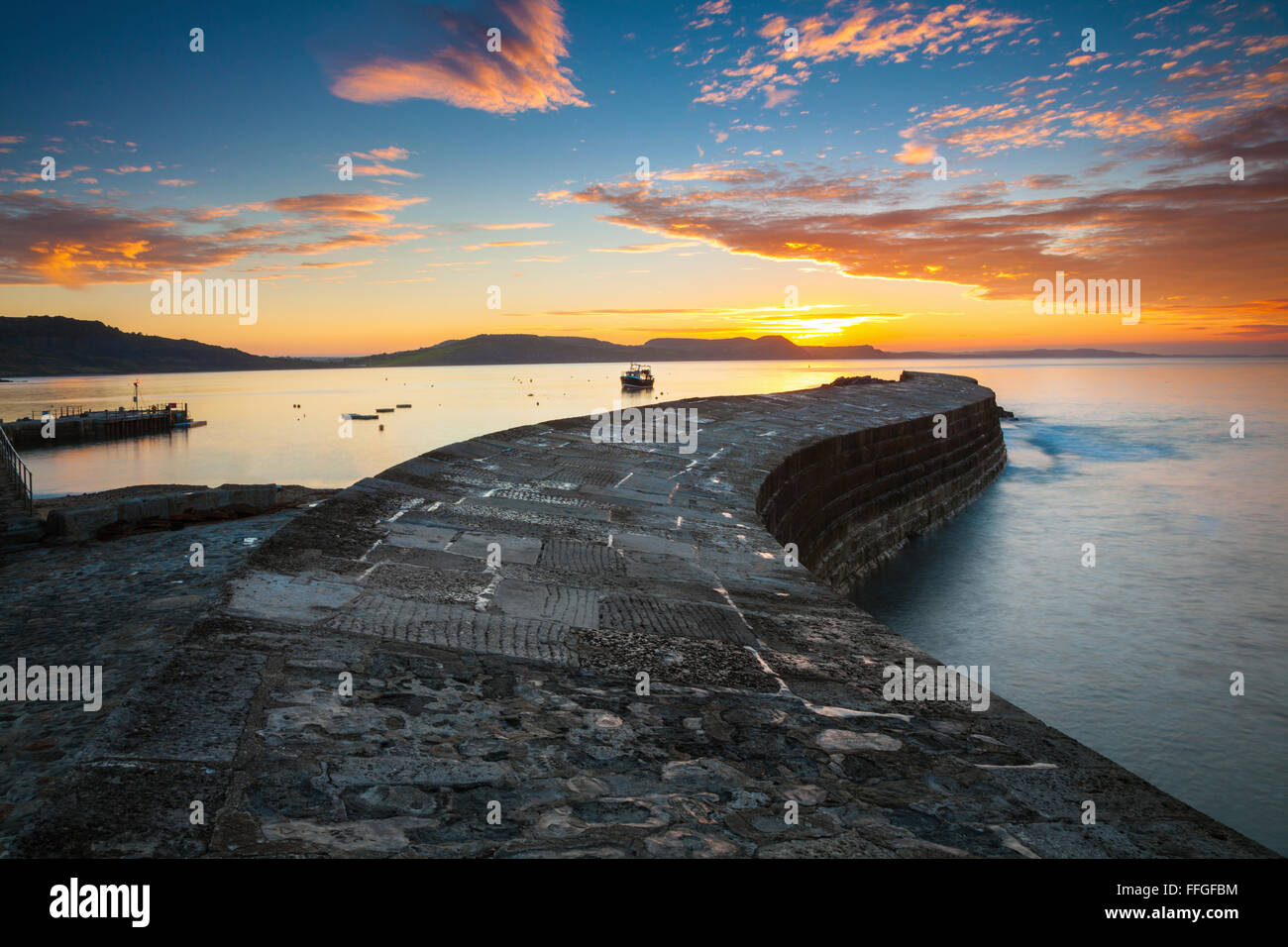 The Cobb at Lyme Regis on the south coast of Dorset, captured  at sunrise in September. Stock Photo