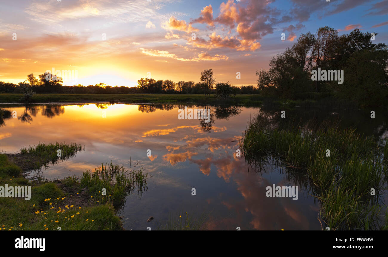 Sunset reflections on the river Stour at Sudbury meadows, Suffolk, England Stock Photo