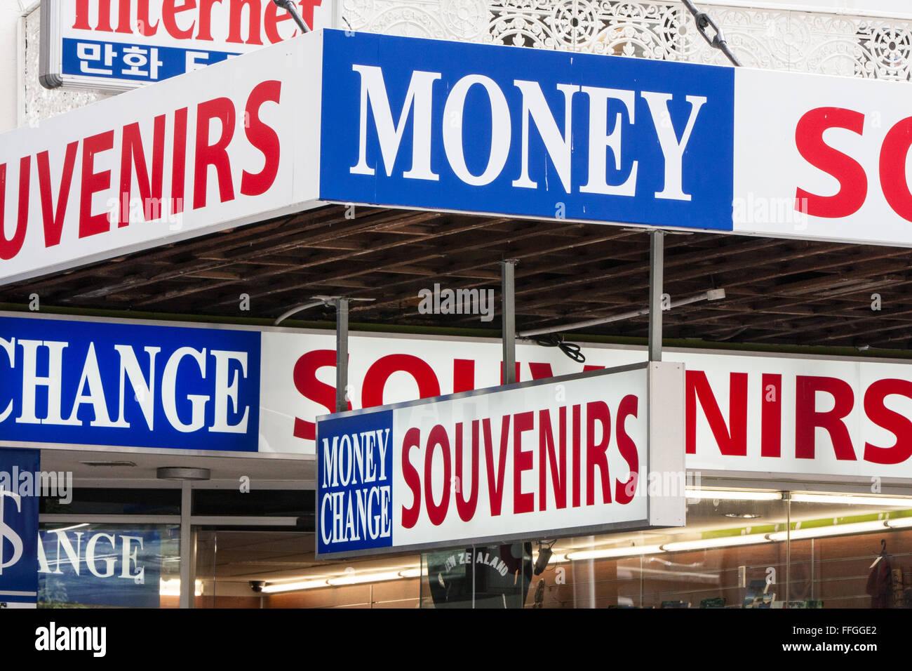 Currency exchange and souvenir signage outside shop on Queen Street in