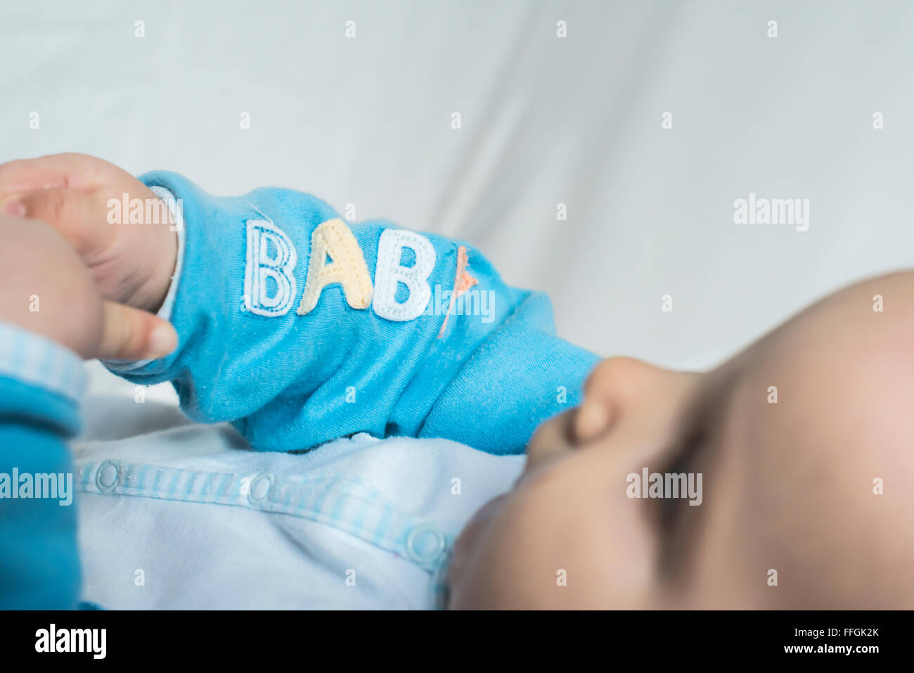 Baby in a bed. Text baby Stock Photo