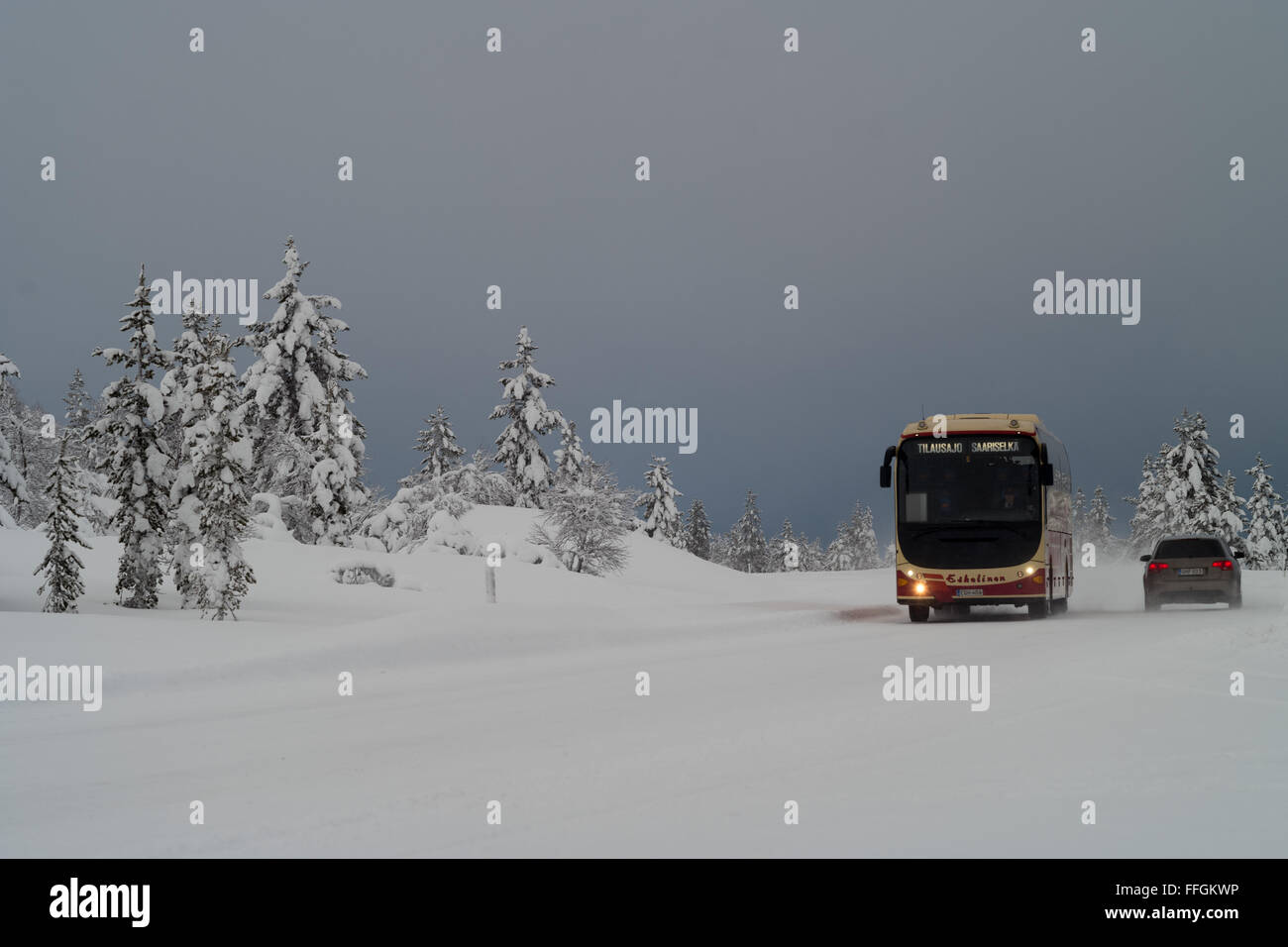 Sodankyla, Lapland, Finland. 11th Feb, 2016. A bus and a car make their way across the wintry landscape on the European route E75 near Sodankyla, Lapland, Finland, 11 February 2016. The E 75 is a 4340-kilometre-long European route running from north to south. Photo: PETER ENDIG/dpa - NO WIRE SERVICE -/dpa/Alamy Live News Stock Photo