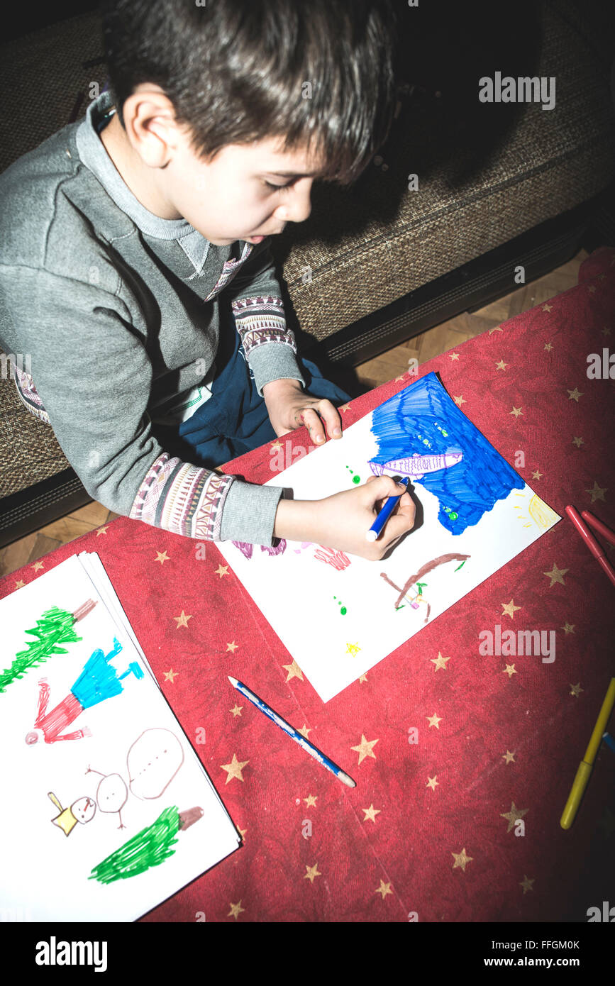 Child painting. Direct on camera flash Stock Photo - Alamy