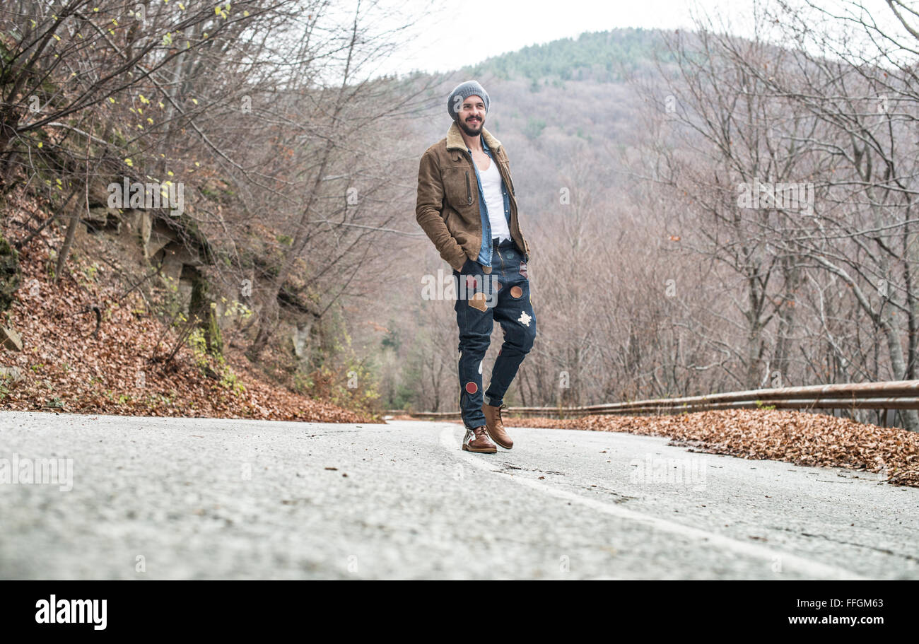 Young men walking on the road Stock Photo