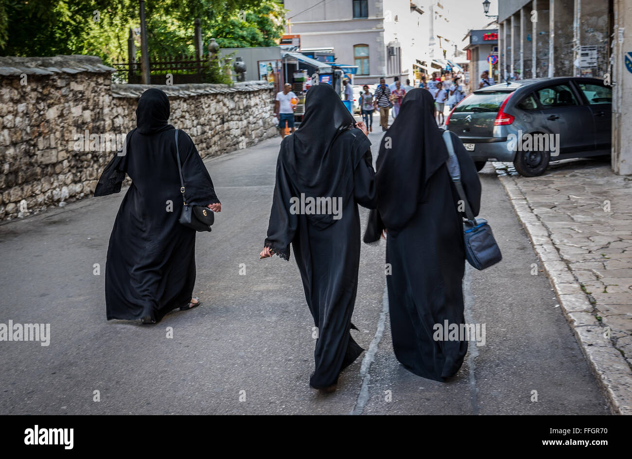 Muslim women on Brace Fejica pedestrian street in Mostar city, Bosnia and Herzegovina Stock Photo