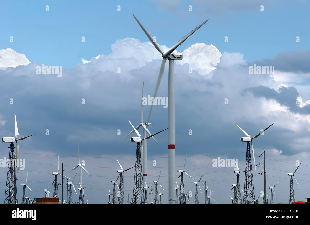 Wind turbines against clouds and blue sky Stock Photo - Alamy