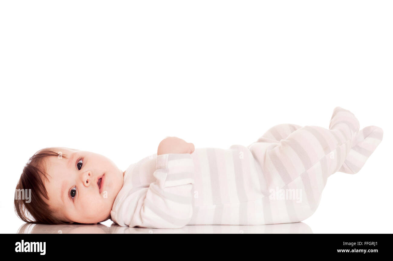 Cute Baby Lying On Your Back On White Floor Background And Smiling