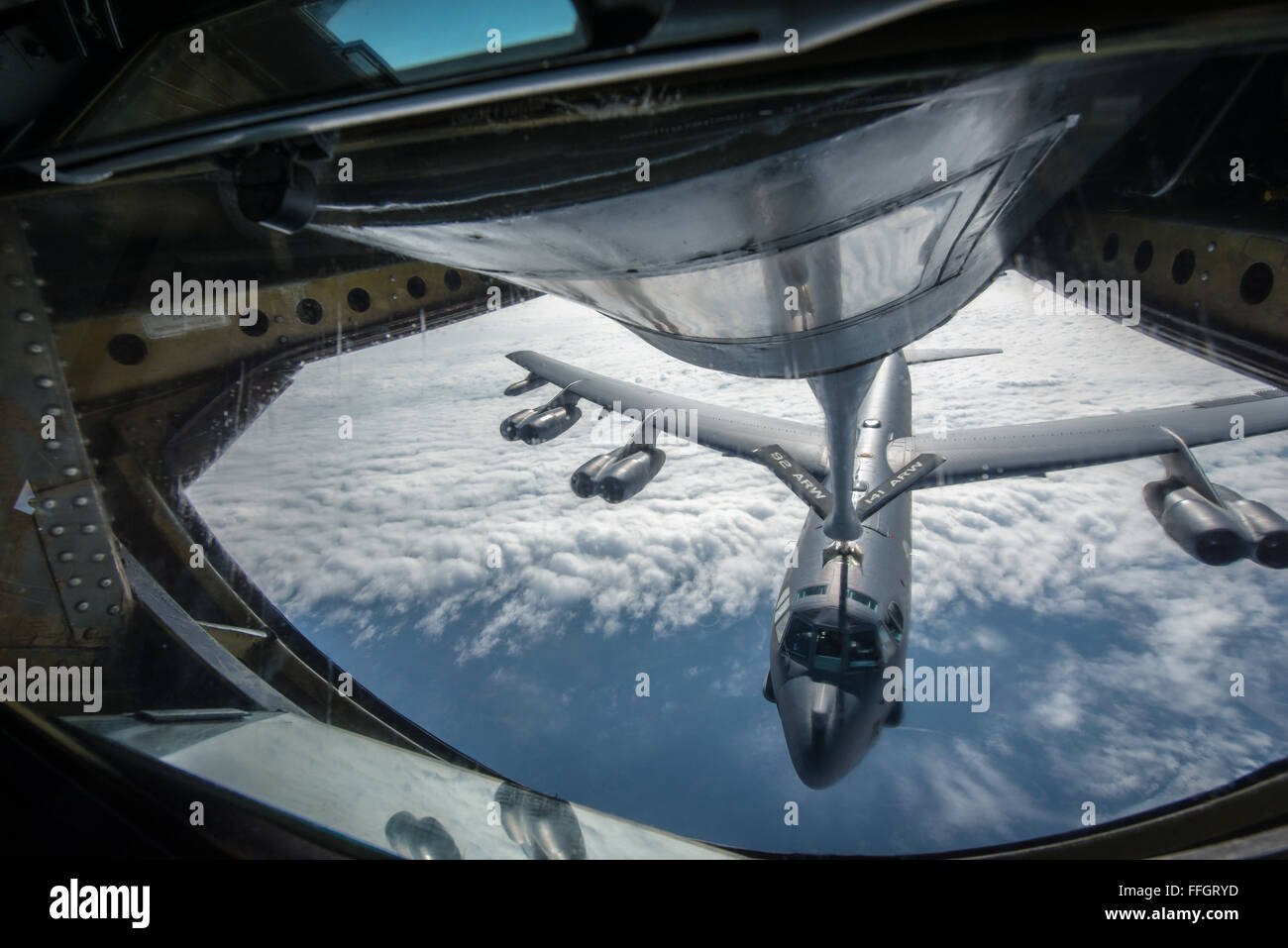 A KC-135 Stratotanker connects with a B-52H Stratofortress from Minot Air Force Base, N.D., during an aerial refueling mission over the Alaskan coastline as part of exercise Amalgam Dart 15-2 May 28, 2015. The annual North American Aerospace Defense Command exercise affords American and Canadian forces field training aimed at improving NORAD's operational capability in a binational environment. The exercise spanned two forward operating locations in CanadaÕs Northwest Territories, two U.S. Air Force bases in Alaska, and a mobile radar site in Resolute, Nunavut, as well as the sky over much of Stock Photo