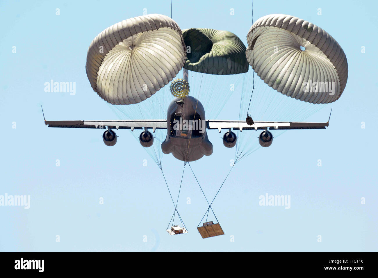 Members of the 58th Airlift Squadron release unilateral airdrop training loads from a C-17 Globemaster III during an airdrop training mission at the Sooner Drop Zone April 11, 2014, near Hollis, Okla. The 97th Aerial Operations Flight prepares airdrop cargo pallets and loads them onto the C-17s. Their mission provides C-17 aircrews with realistic training scenarios, which consist of on and off loading general cargo and vehicles as well as aerial delivery materials for airdrop training. Stock Photo