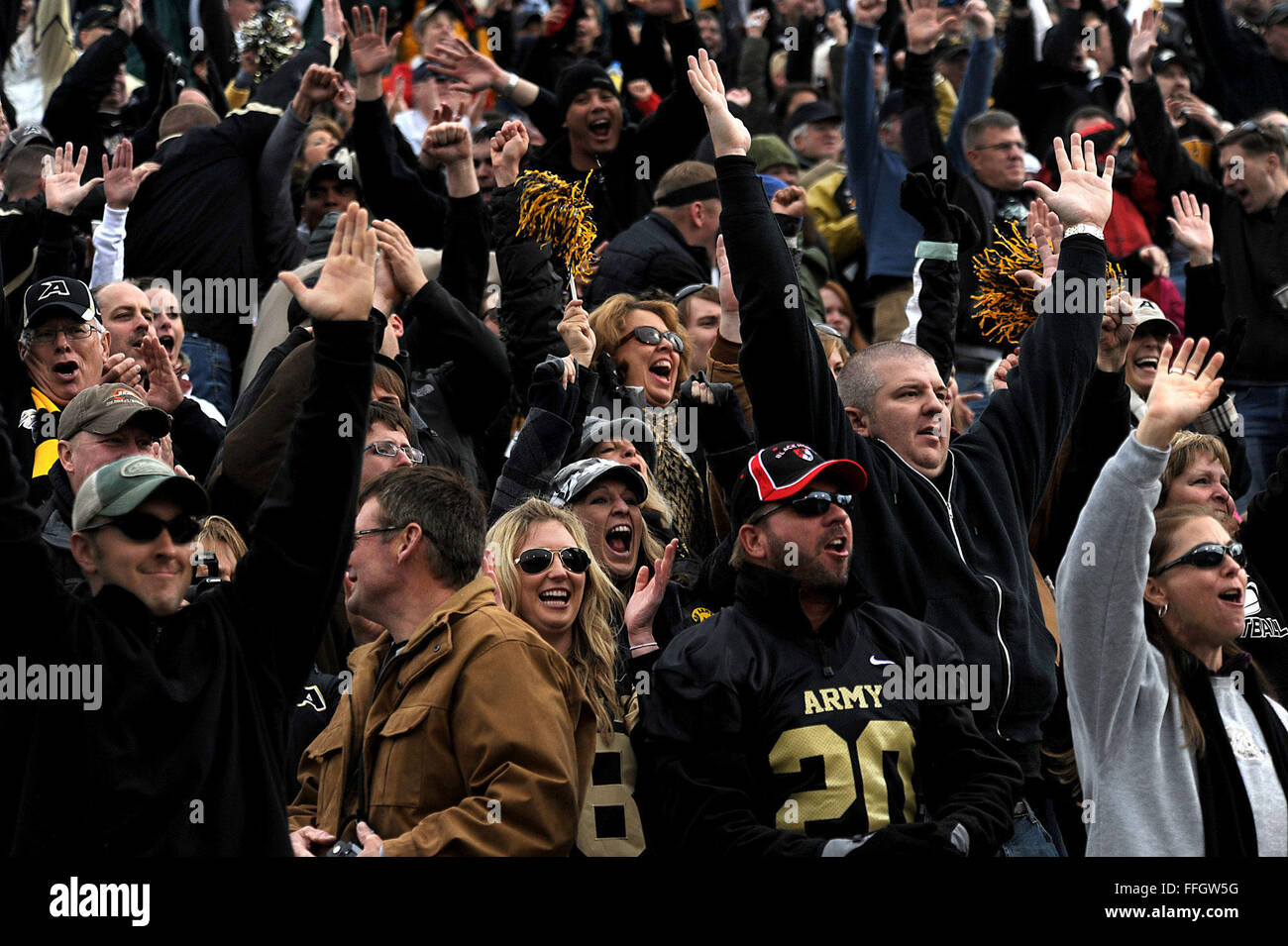 U.S. Military Academy at West Point football fans cheer after their team scores a touchdown during the Nov. 5 game. Army was leading by 14-0 going into halftime. Stock Photo