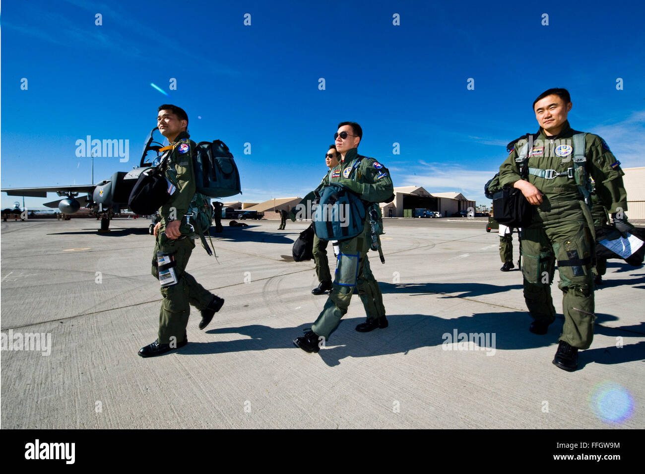 Republic of Korea Air Force pilots walk toward their F-15 Strike Eagles during Red Flag 12-2 at Nellis Air Force Base, Nev. Red Flag is a combat training exercise involving the air forces of the United States and its allies. The exercise is hosted north of Las Vegas on the Nevada Test and Training Range. Stock Photo