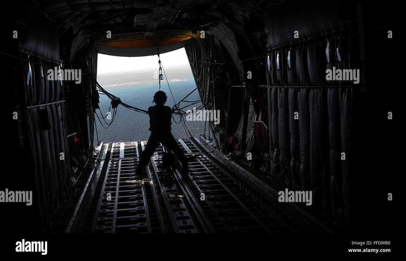 Staff Sgt. Robert Hafer, a loadmaster with the 40th Airlift Squadron at Dyess Air Force Base, Texas, secures static line after an airdrop out of a C-130J Hercules during Large Package Week at Pope Army Air Field, N.C. LPW is an exercise that utilizes several Air Force C-130 Hercules and C-17A Globemaster III aircraft to strategically airdrop troops and cargo. Stock Photo