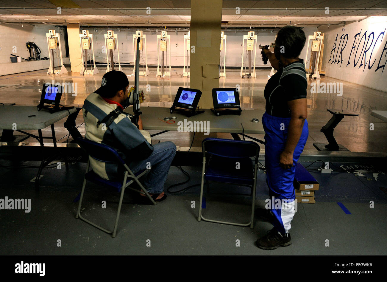Retired Maj. Gwen Sheppard squeezes in some pistol shooing after rifle practice during the Air Force team's Warrior Games selection camp at the U.S. Air Force Academy in Colorado Springs, Colo. Sheppard also acts  as a coach and mentor for her teammates in the shooting and archery events. Stock Photo
