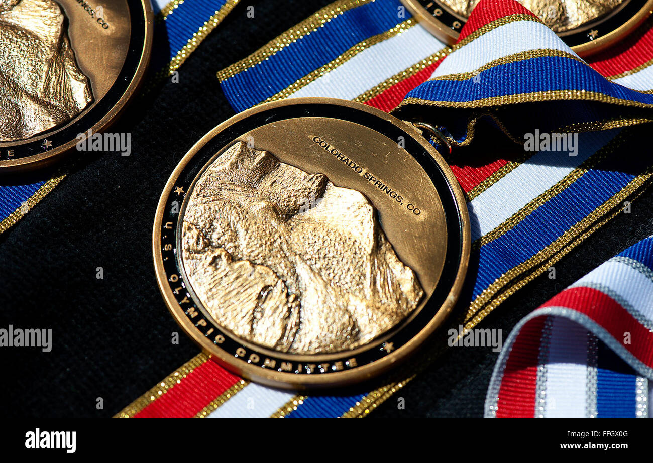 Gold medals sit on a table as athletes take part in the track and field competition of Warrior Games 2012. Stock Photo