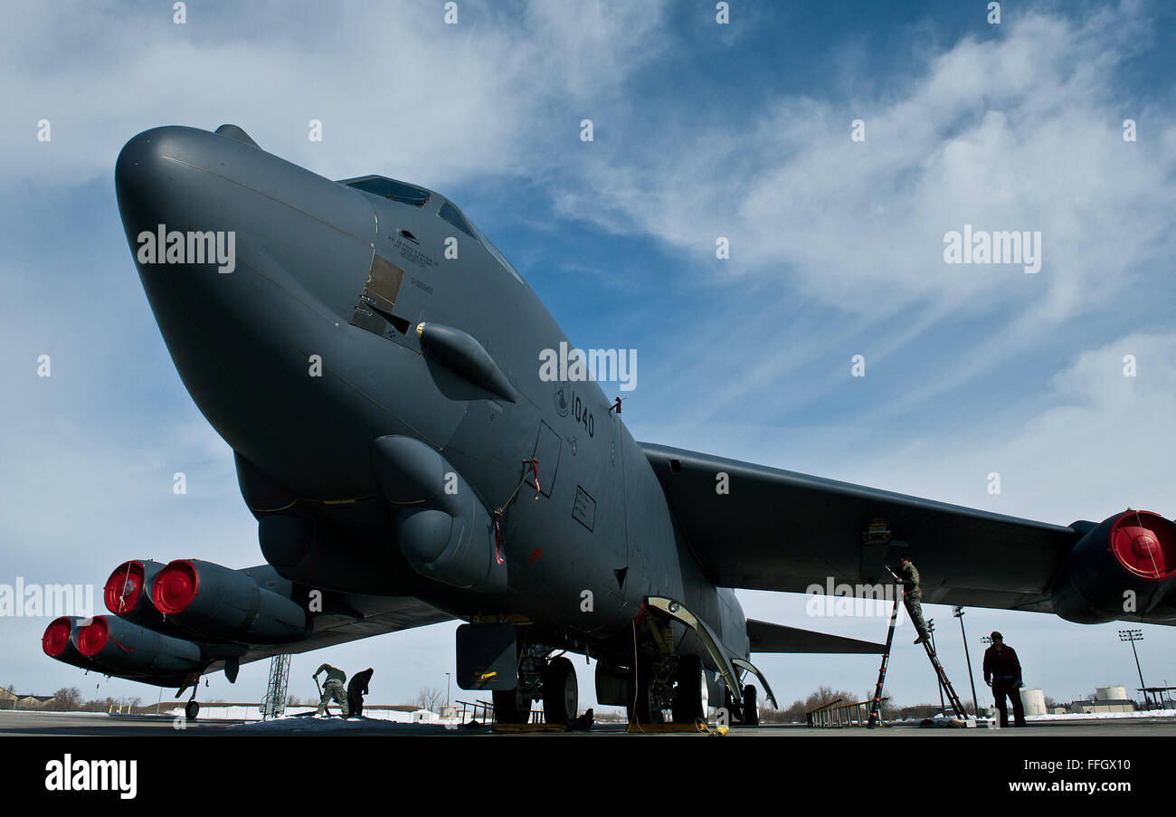 Aircraft maintainers and armament technicians work on Tail No. 1040, the youngest B-52 Stratofortress in the Air Force arsenal at 50 years old, on the Minot Air Force Base flightline. Stock Photo