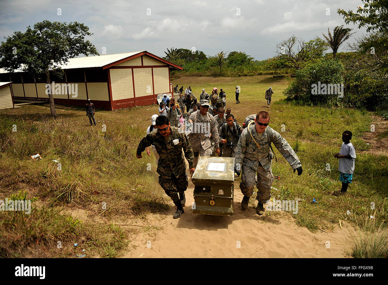 U.S. military members deployed to Joint Task Force-Bravo's Medical Element at Soto Cano Air Base, Honduras, pack up and take their supplies to the beach to load onto the helicopters after seeing 533 patients in the coastal village of Batalla over two days. Stock Photo