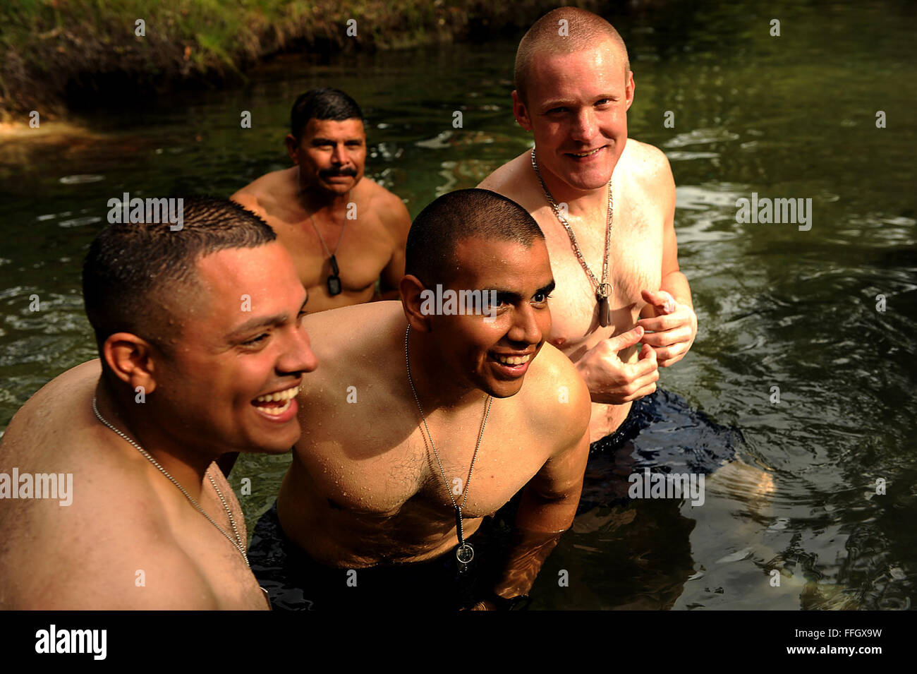 Airmen from the Joint Task Force-Bravo Medical Element, based at Soto Cano Air Base, Honduras, cool off in a stream after a long day of seeing patients in the village of Wawina. Stock Photo