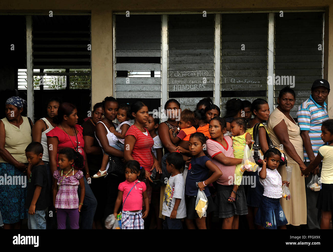 Local Hondurans stand in a line waiting to be seen by Joint Task Force-Bravo Medical Element professionals. The medical team used a local schoolhouse as their makeshift clinic Stock Photo