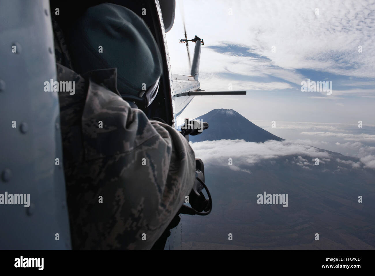 Tech. Sgt. Juaacklyn Denny, 374th Airlift Wing broadcaster, captures video from a UH-1 during the Samurai Surge. The 459th AS and 36th AS conducted the Samurai Surge, an all-day flying exercise that tests pilots in several areas. Stock Photo