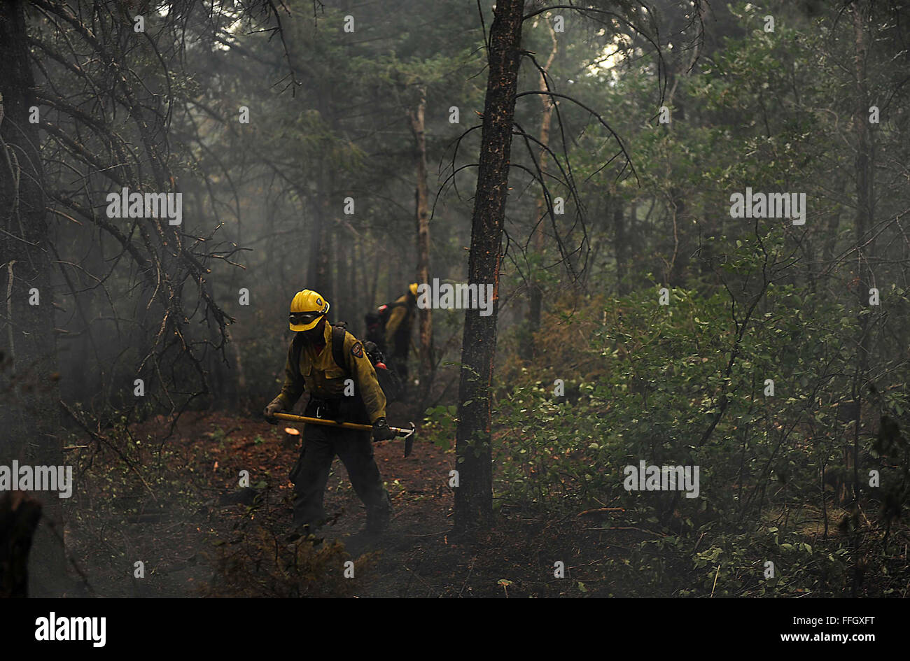 Vandenberg Air Force Base Hot Shot fire fighter Lupe Covarrubias cuts a fire line on June 28, 2012 in the Mount Saint Francois area of Colorado Springs, Co. while helping to battle several fires in Waldo Canyon.  The Waldo Canyon fire has grown to 18,500 acres and burned over 300 homes. Currently, more than 90 firefighters from the Academy, along with assets from Air Force Space Command; F.E. Warren Air Force Base, Wyo.; Fort Carson, Colo.; and the local community continue to fight the Waldo Canyon fire. Stock Photo