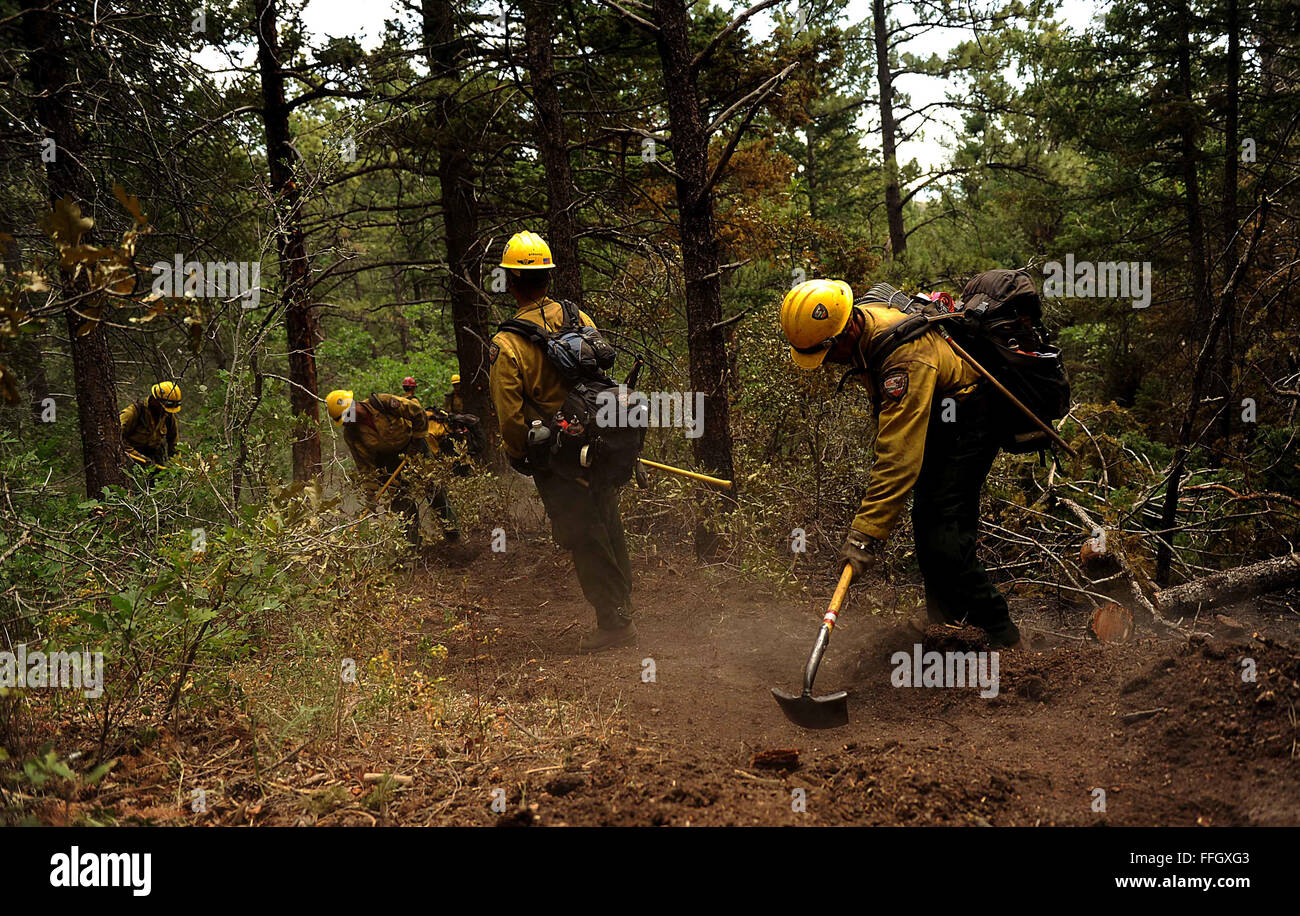 Vandenberg Air Force Base Hot Shot fire fighters cut a fire line on June 28, 2012 in the Mount Saint Francois area of Colorado Springs, Co. while helping to battle several fires in Waldo Canyon.  The Waldo Canyon fire has grown to 18,500 acres and burned over 300 homes. Currently, more than 90 firefighters from the Academy, along with assets from Air Force Space Command; F.E. Warren Air Force Base, Wyo.; Fort Carson, Colo.; and the local community continue to fight the Waldo Canyon fire Stock Photo