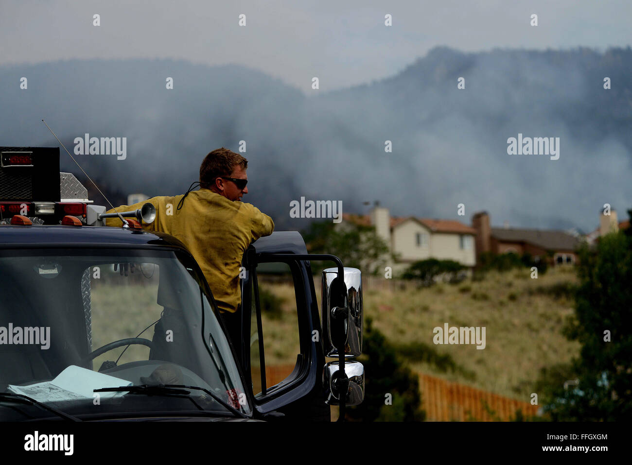 Vandenberg Air Force Base Hot Shot fire fighter Richard Strange looks out at his worksite for the day on June 28, 2012 in the Mount Saint Francois area of Colorado Springs, Co. His team will be cutting a fire line while helping to battle several fires in Waldo Canyon.  The Waldo Canyon fire has grown to 18,500 acres and burned over 300 homes. Currently, more than 90 firefighters from the Academy, along with assets from Air Force Space Command; F.E. Warren Air Force Base, Wyo.; Fort Carson, Colo.; and the local community continue to fight the Waldo Canyon fire. Stock Photo