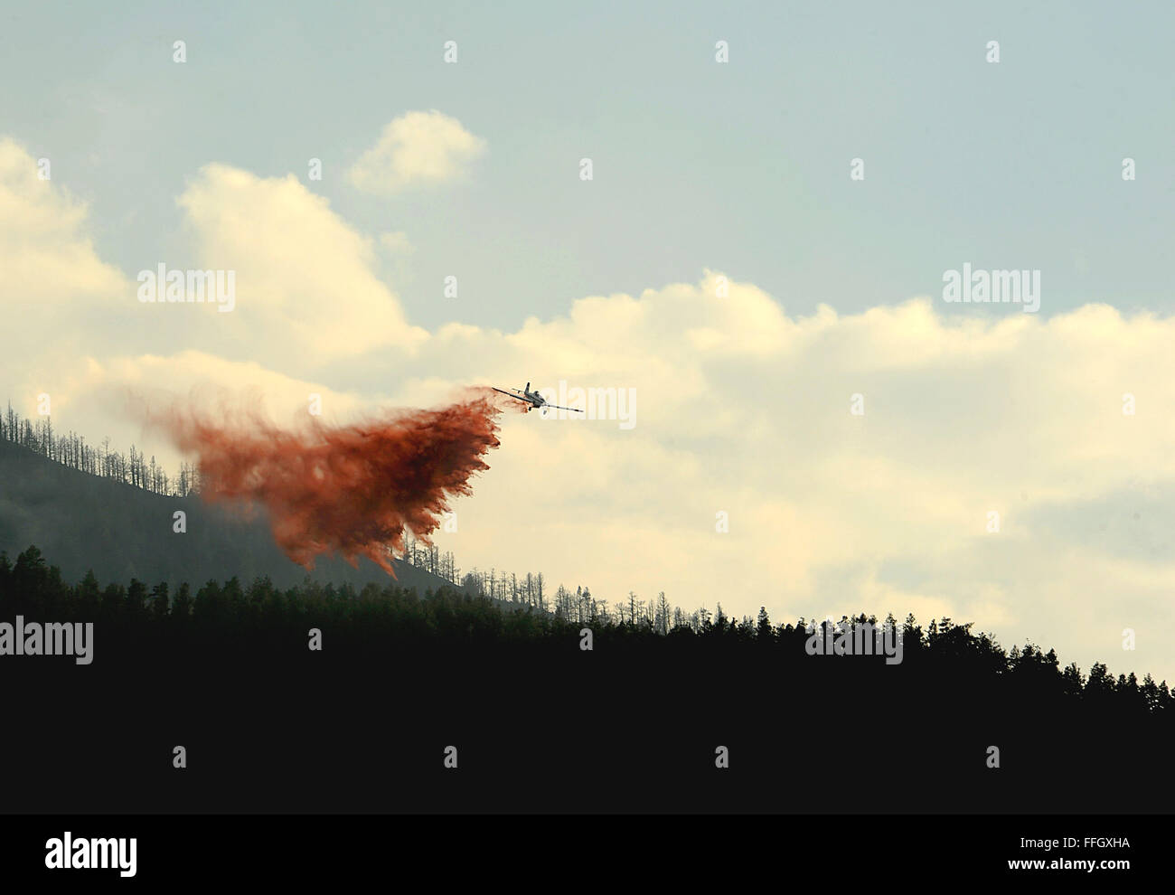 A small propelar plane drops fire retardant on the fire as firefighters continued to battle the blaze that burned into the evening hours in Waldo Canyon on the U.S. Air Force Academy. Stock Photo