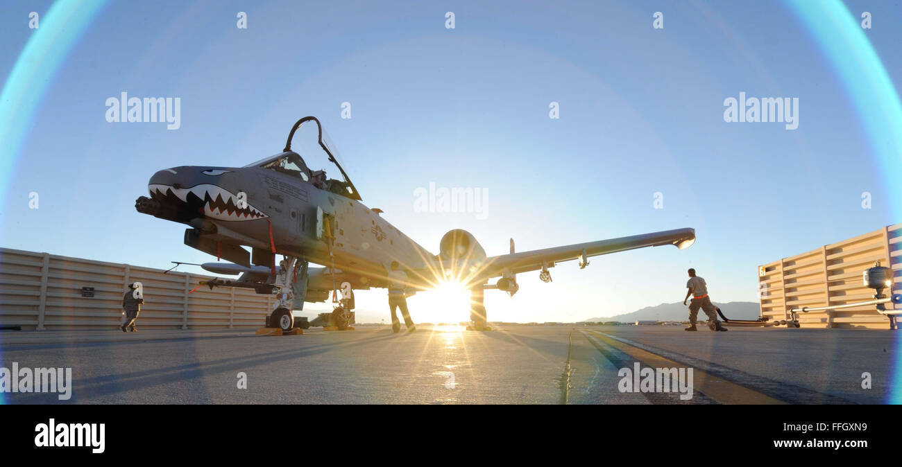 The sun sets July 16, 2012, as an A-10C Thunderbolt II sits on the ramp at Nellis Air Force Base, Nev. Aircrew from the 23d Wing, 74th Fighter Squadron, at Moody Air Force Base, Ga., are flying missions from Nellis during exercise Red Flag 12-4. The training sorties will unleash up to eight MK-82 bombs per day and as much as 5,000 rounds from the A-10's 30 mm cannons. Stock Photo