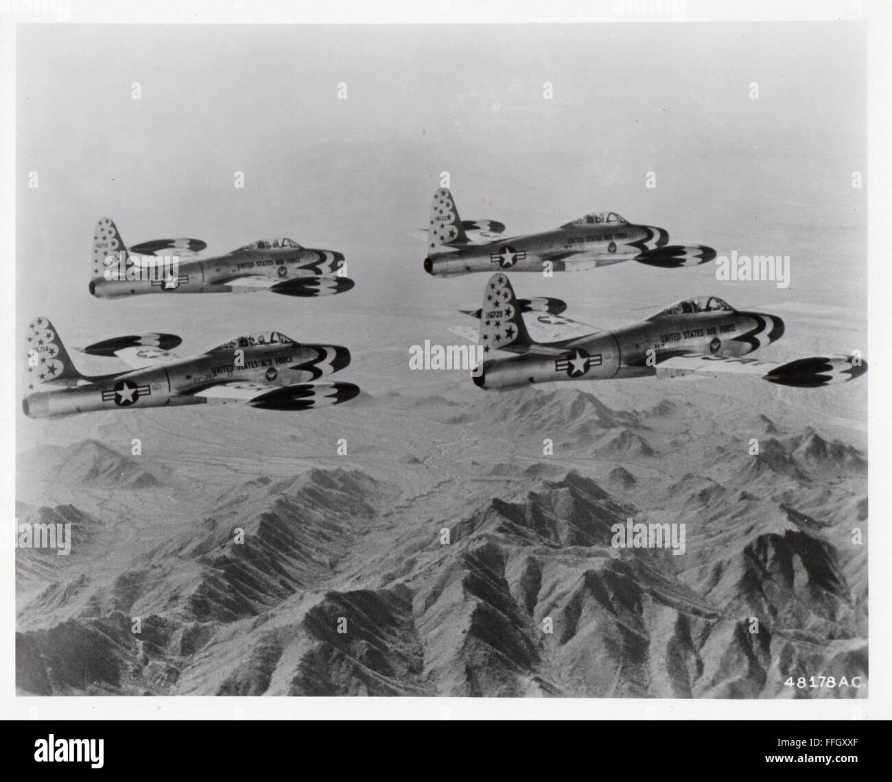 Thunderbirds F-84G Thunderjets fly in formation. The team utilized the “G” model from 1953 to 1954.  The straight-wing configuration of the F-84G was considered well suited for aerobatic and demonstration maneuvers, though the aircraft could not exceed the speed of sound. Stock Photo
