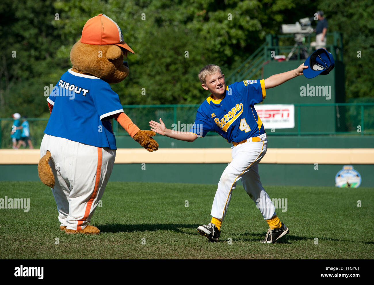 Europe little leaguer Nathan Kranz shakes hands with the dugout mascot before their first game. Stock Photo