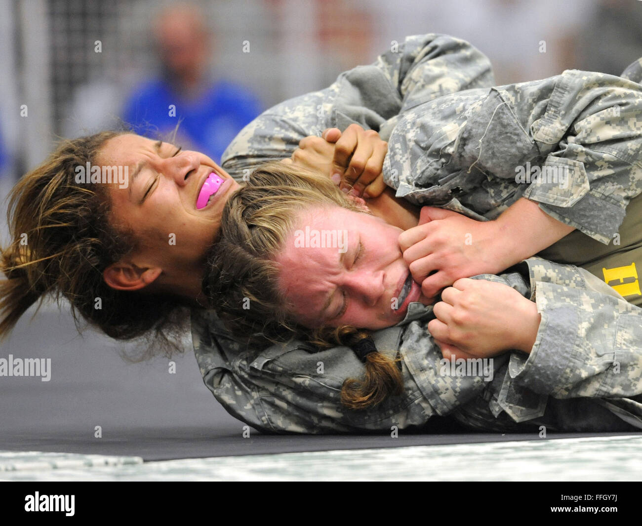 U.S. Army Sgt. 1st Class Joe Baker demonstrates a choke hold on Officer  Candidate Wendy McDougall during combatives training at the Bethany Beach  Training Site in Bethany Beach, Del., June 7, 2015.