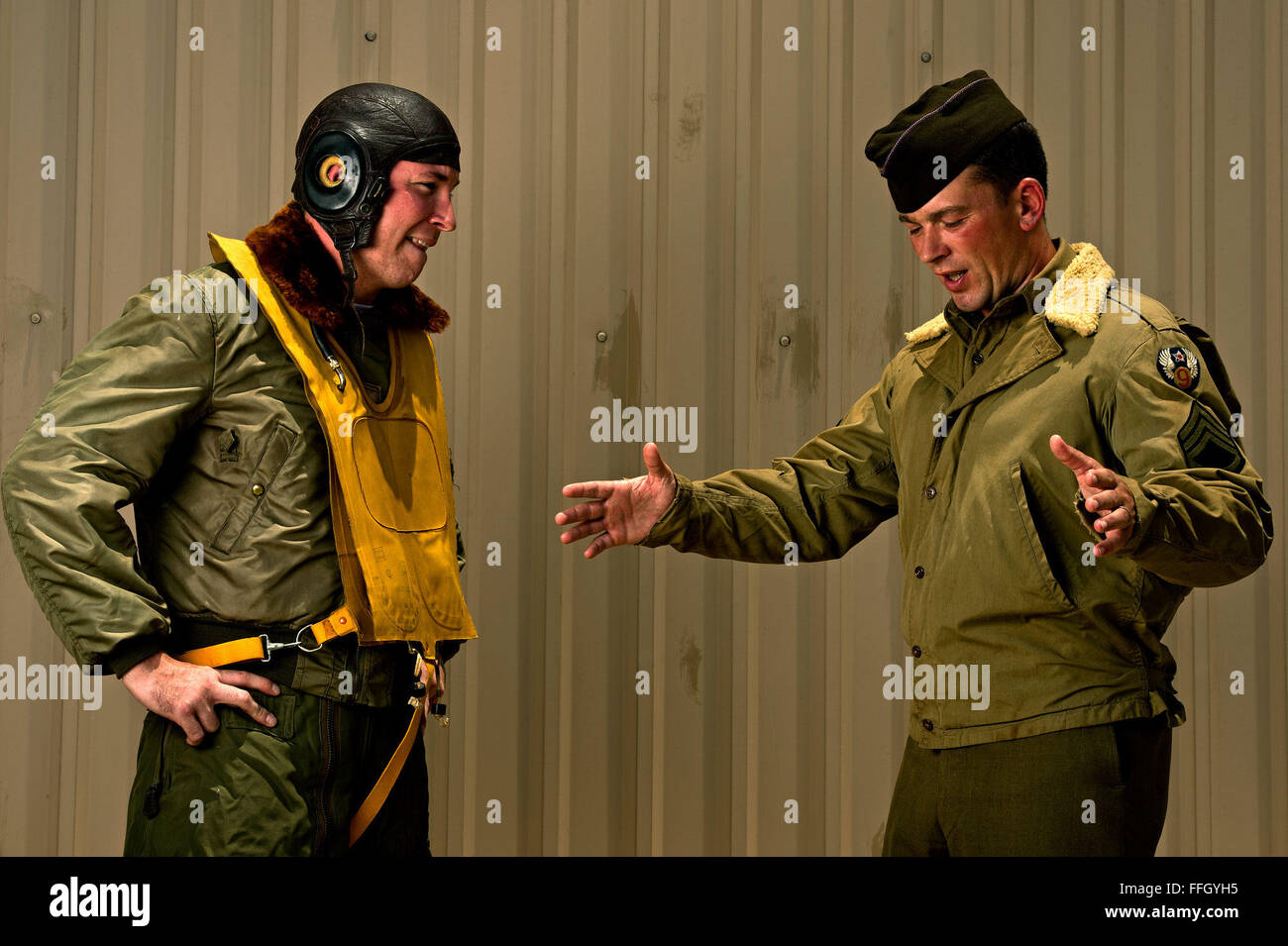 Derick Yara (left) represents an enlisted pilot wearing a World War II two-piece heavy flight suit, and Master Sgt. Robert Husted wears an M-41 field jacket with wool collar modified by an Army Air Corps enlisted member Stock Photo