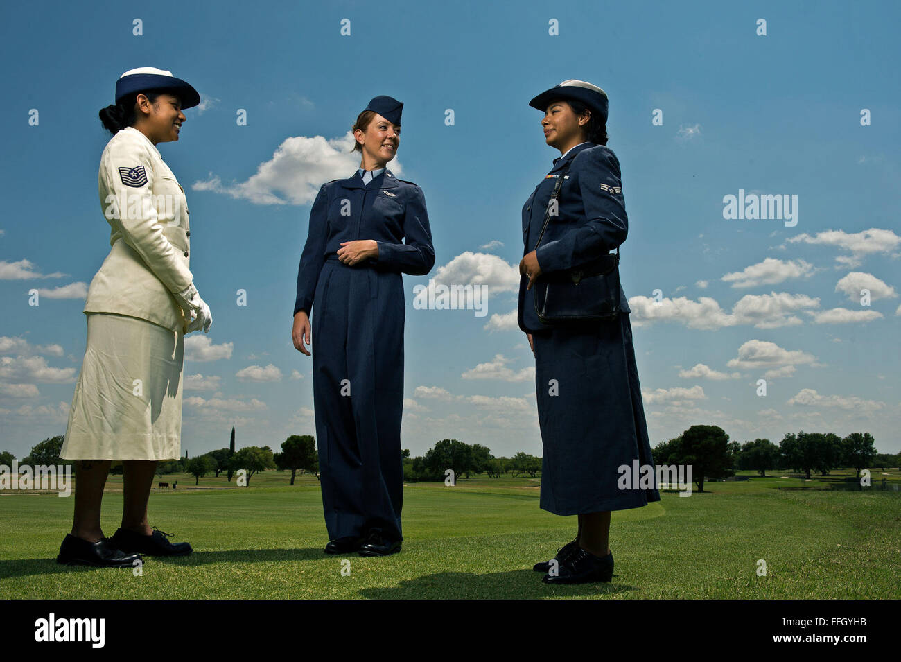 Airman 1st Class Leona Guy (left), Jill Logston (center) and Doris Hernandez wear various Women in the Air Force uniforms from the 1950s and 1960s. Guy is wearing the white summer service dress, Logston the Shade 84 WAF Nursing Flight Jacket and Hernandez the Shade 84 WAF service dress. Stock Photo