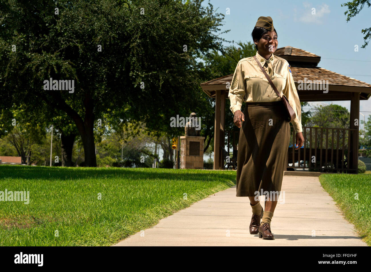 Master Sgt. Deborah A. Joseph strolls through a park wearing a World War II and Air Force transitional period Women’s Auxiliary Corps and WAF uniform. Stock Photo