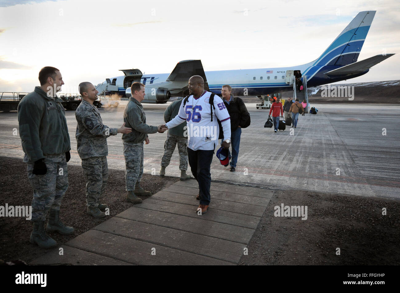 Base leaders greet military and civilian personnel as they arrive at Thule AB via a contracted Douglas DC-8. The DC-8 travels weekly to Thule AB to transport both supplies and personnel. The air base is the military's most northern installation, located 750 miles north of the Arctic Circle. Stock Photo