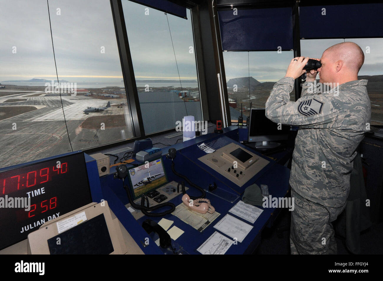 Master Sgt. Lowell Morris keeps a lookout to ensure operations run smoothly from the air traffic control tower at Thule AB. Morris is the complex chief controller assigned to the 821st Support Squadron. Stock Photo