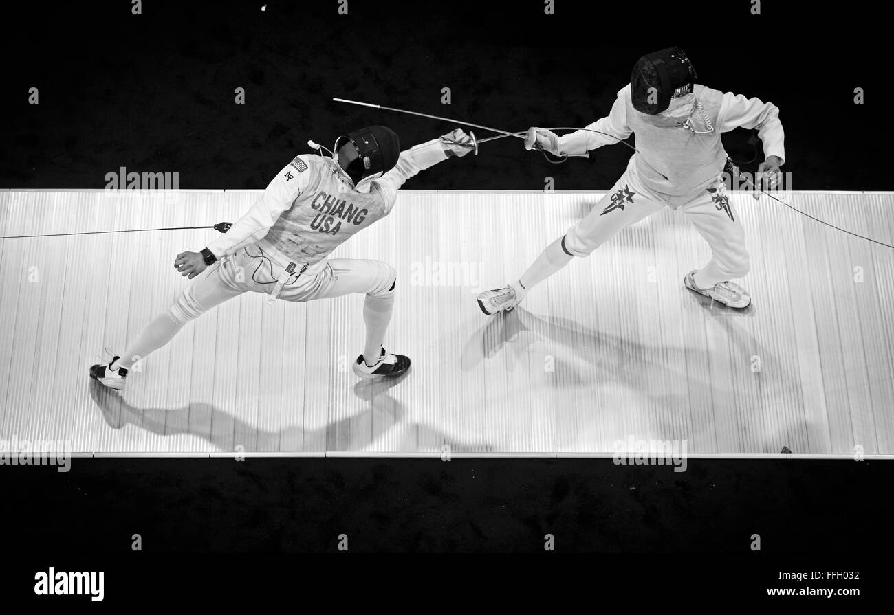 During a foil fencing match, Alexander Chiang reaches out and hits his opponent to score a point. Foil is one of the three weapons of modern fencing, with the other two being ŽpŽe and saber. Stock Photo