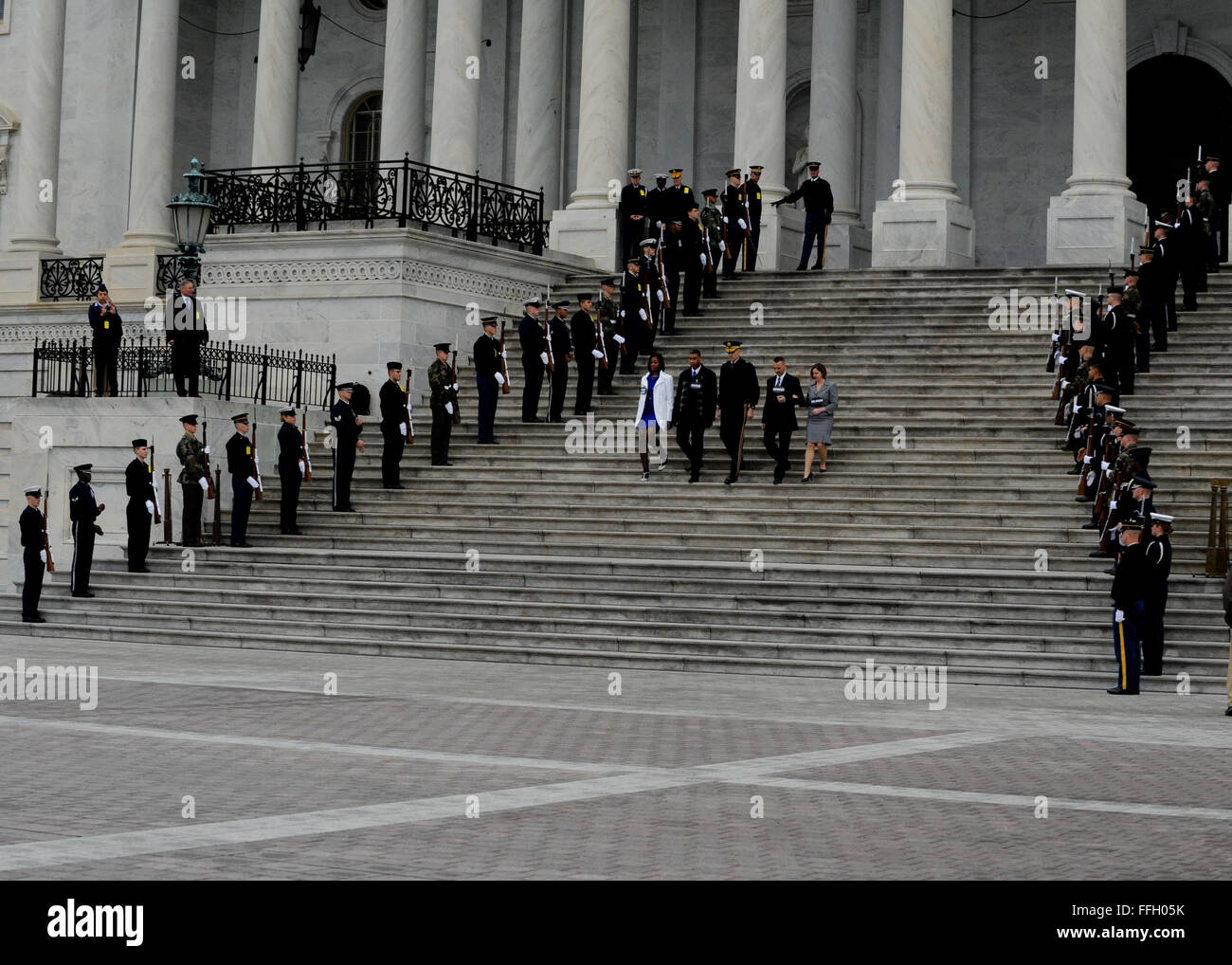 A joint honor guard salutes as role players representing the president, vice president and their spouses descend the U.S. Capitol steps during the presidential inauguration dress rehearsal in Washington, D.C. Stock Photo