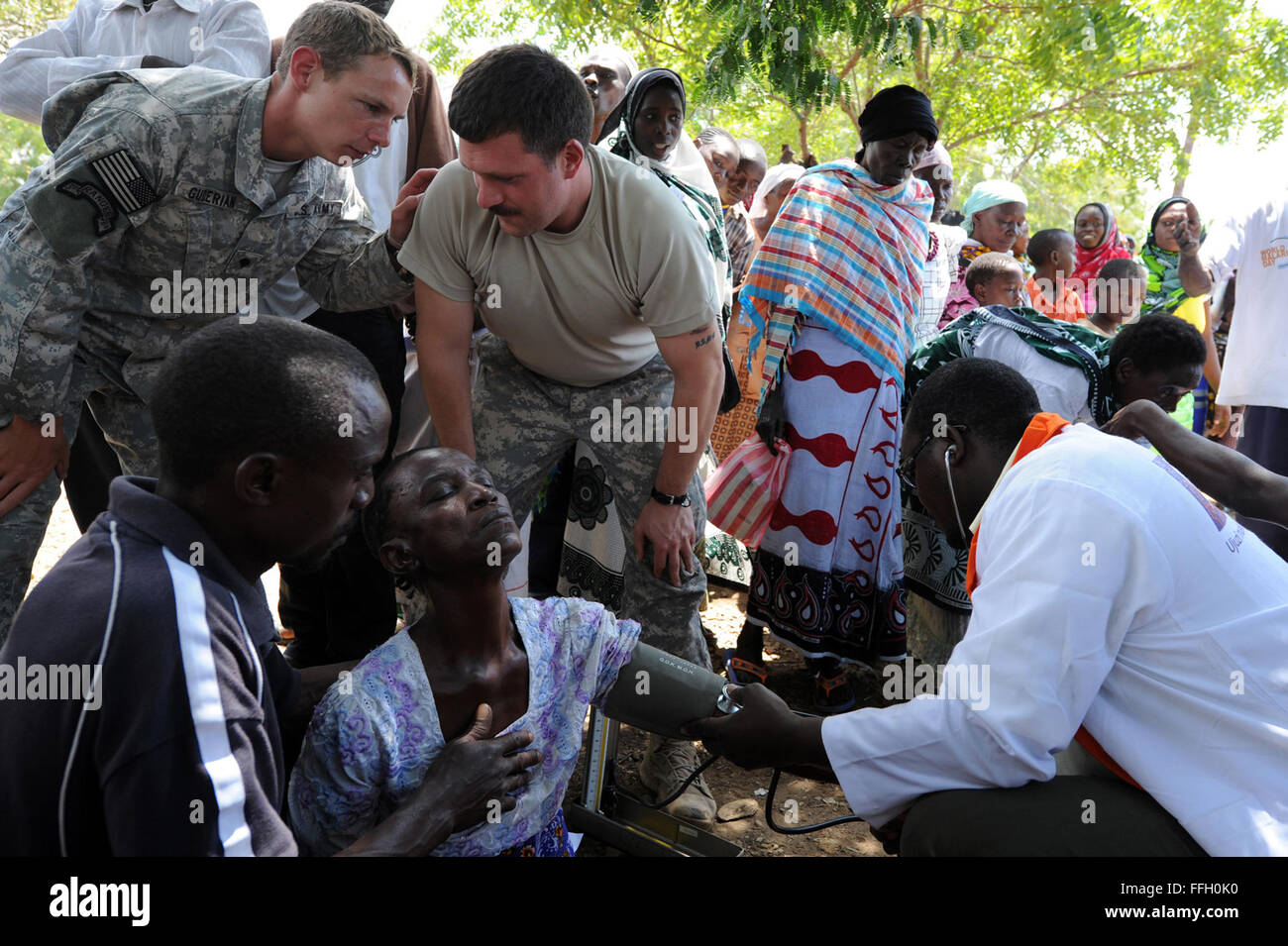 U.S. Army Staff Sgt. Matthew Hoffman, Headquarters and Headquarters Company 448th Civil Affairs Battalion, right, and Spc. Josh Guderian, Maritime Civil Affairs and Security Team sergeant, discuss a patient who collapsed during a Medical Civic Action Program, or MEDCAP, in Lunga Lunga, Kenya, Aug. 24, 2012. Combined Joint Task Force - Horn of Africa, or CJTF-HOA, was involved in the MEDCAP. CJTF-HOA participates in many MEDCAPs across East Africa, aiming to strengthen the capabilities of community health workers, enhance overall community health, provide medical care to underserved communities Stock Photo