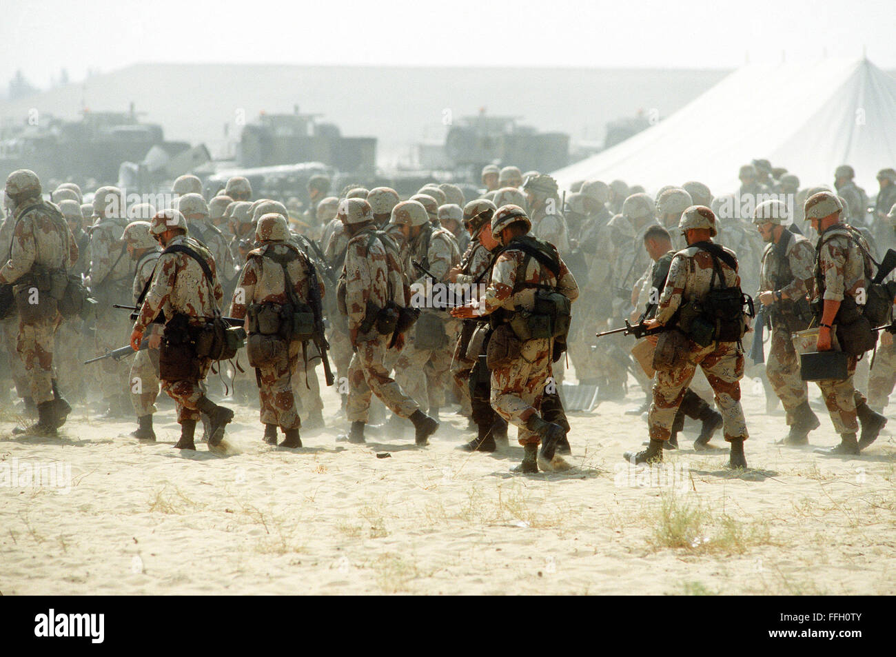 U.S. military personnel arrive at a base camp during Operation Desert Shield. U.S. Stock Photo