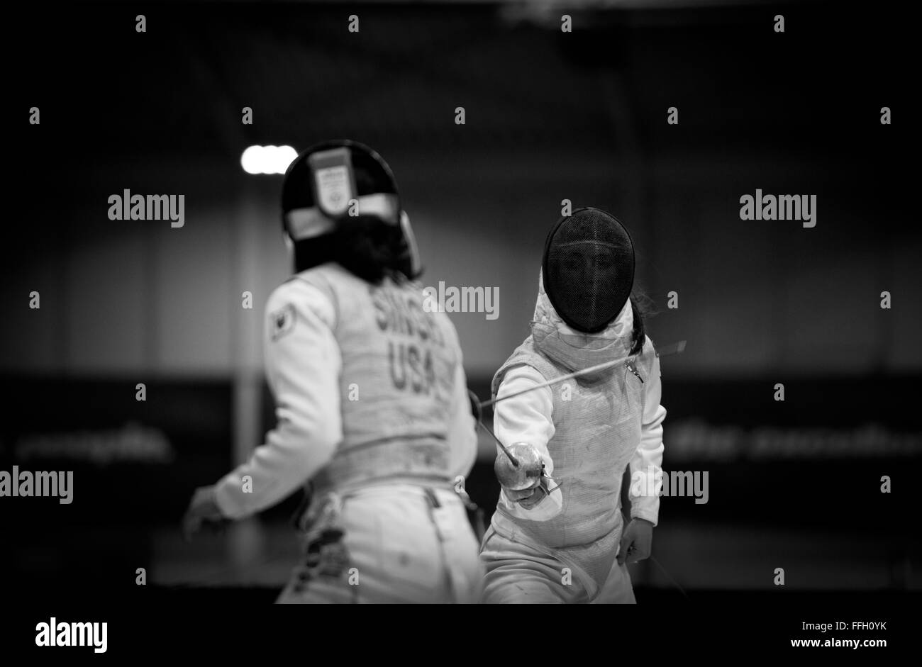 Air Force Academy cadet Madeleine Girardot battles Ambika Singh, from Princeton University, during the 2014 NCAA Fencing Championships at Ohio State University in Columbus, Ohio. Girardot placed 21st in women's foil after winning six out of 24 matches. Stock Photo