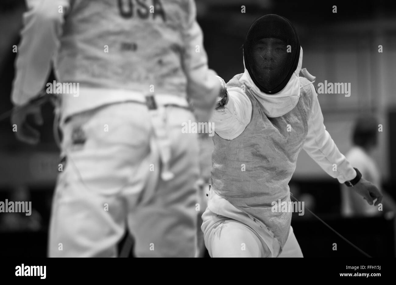 Alexander Chiang reaches out and attempts to score on his opponent. The foil is used as a thrusting weapon only. Contact with the side of the blade from a slap or slash does not result in a score.  Foil is one of the three weapons of modern fencing, with the other two being épée and sabre. Stock Photo