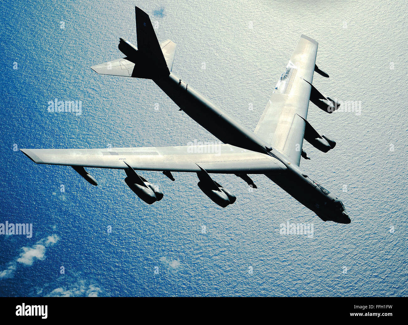A B-52 Stratofortress flies over open water after an air refueling in support of the exercise Rim of the Pacific over the Pacific Ocean. Rim of the Pacific is the world's largest annual multinational maritime exercise. Stock Photo