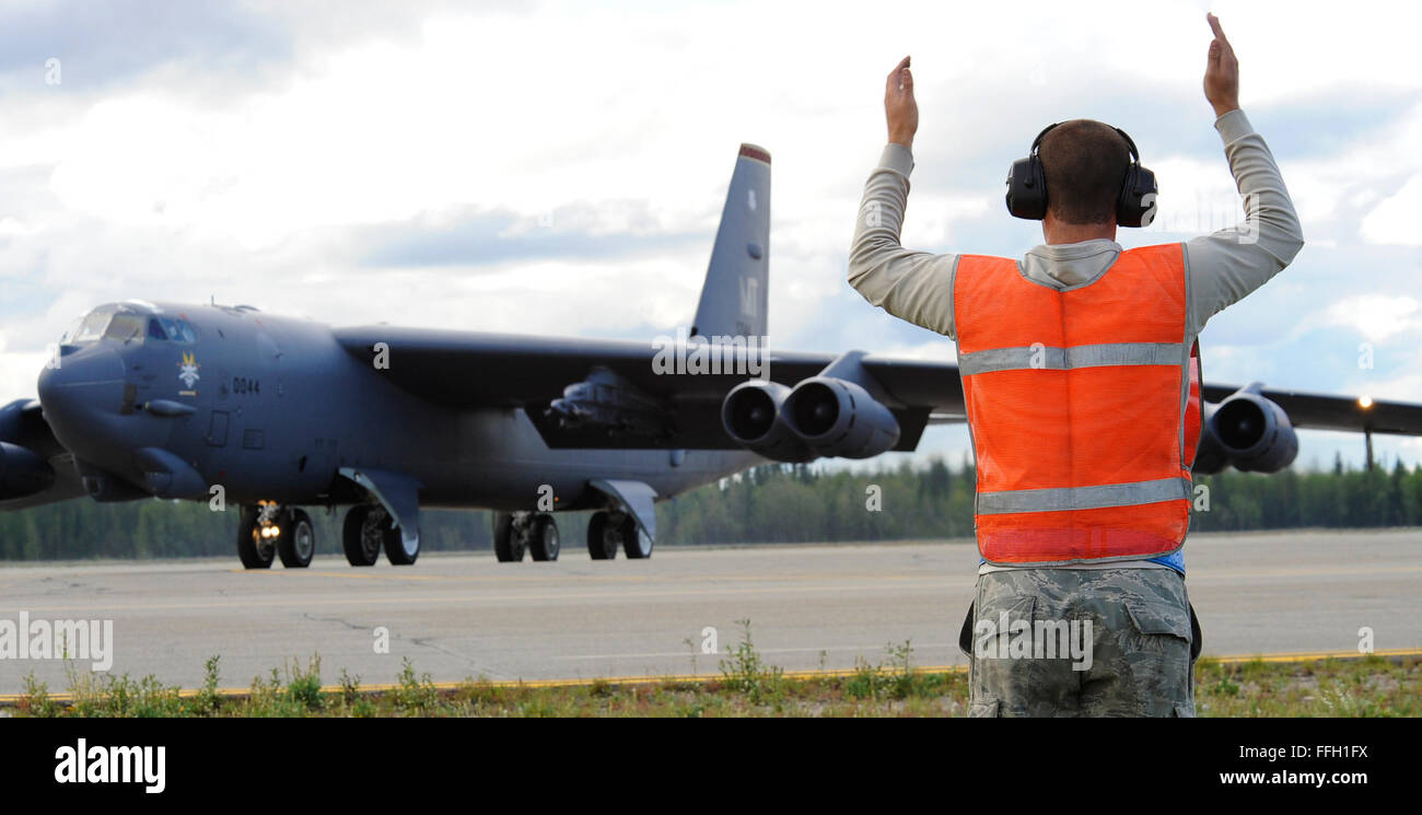 Airman 1st Class Michael Smith, a crew chief assigned to the 69th Bomb Squadron, marshals a B-52H Stratofortress for takeoff during Red Flag-Alaska 11-3 at Eielson Air Force Base, Alaska. Red Flag-Alaska is a series of Pacific Air Forces commander-directed field training exercises for U.S. forces, providing joint offensive counter-air, interdiction, close air support and large force employment training in a simulated combat environment. Stock Photo