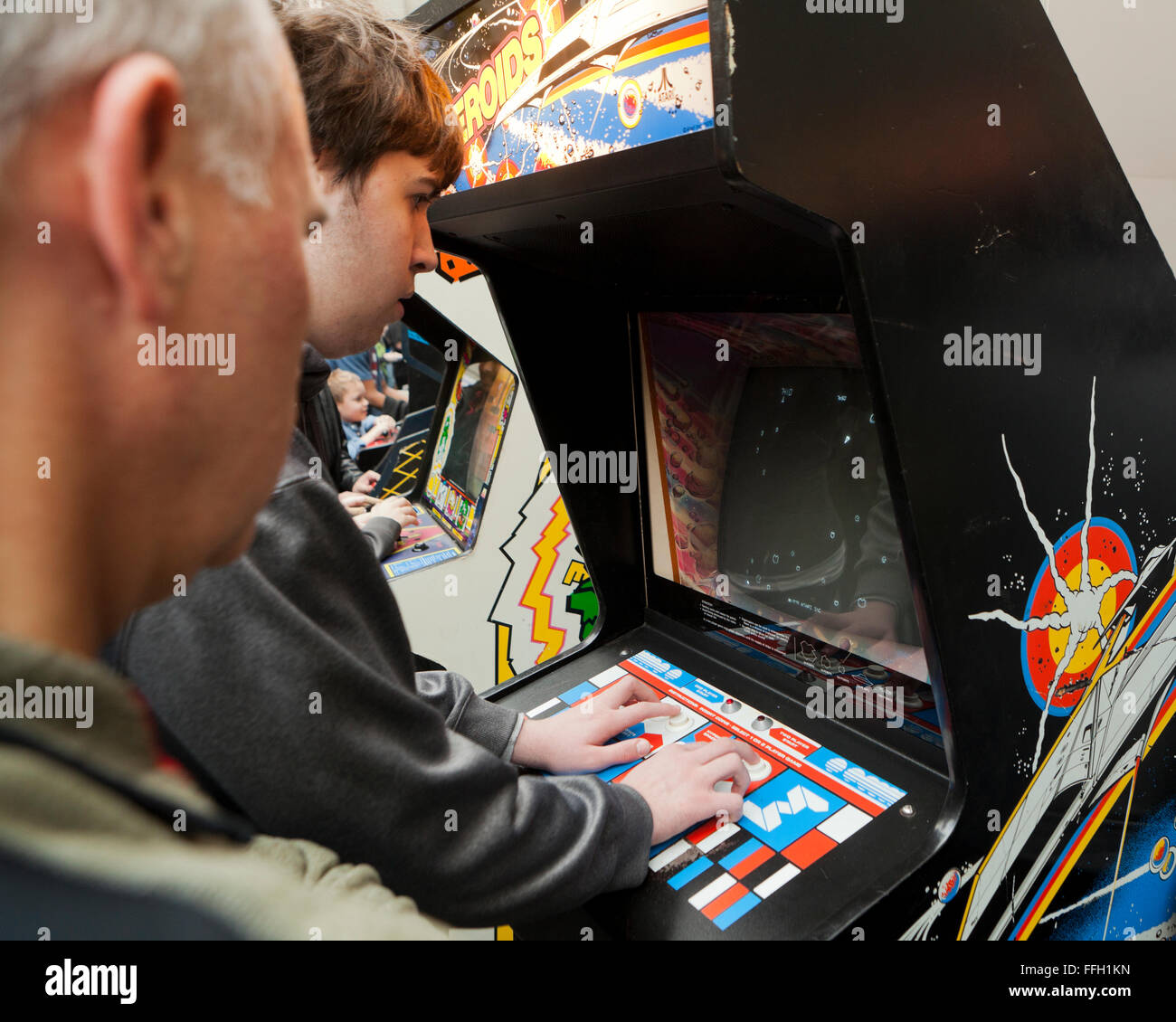 Man playing Asteroids arcade video game - USA Stock Photo