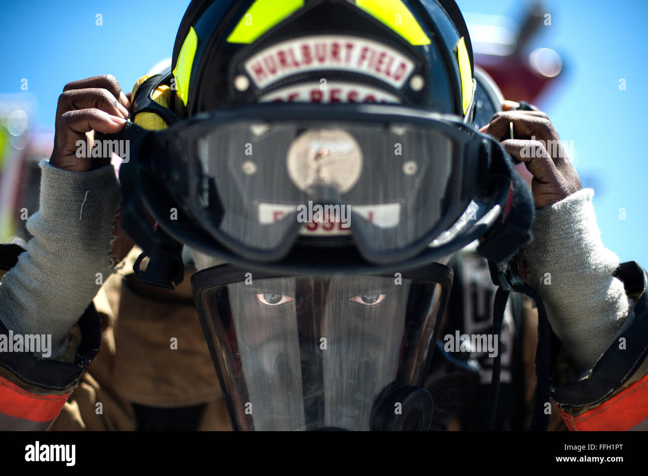 Airman 1st Class Keith Fussell dons his helmet before training at Hurlburt Field, Fla. Firefighters spent more than an hour training on the correct ventilation techniques to maintain proper readiness to complete the mission. Fussell is a firefighter assigned to the 1st Special Operations Civil Engineer Squadron. Stock Photo