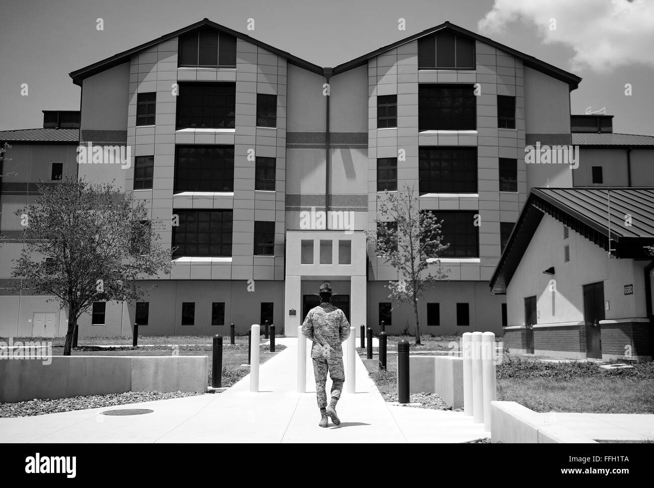 Military training instructor, Tech. Sgt. Chananyah Stuart, enters the 323rd Training Squadron's building at Joint Base San Antonio-Lackland, Texas. Stock Photo