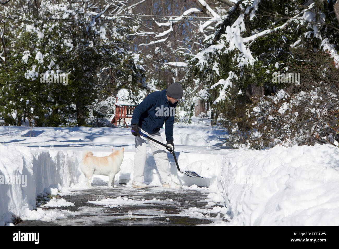 Man shoveling snow from driveway - Virginia USA Stock Photo