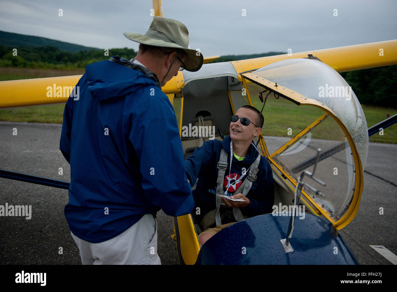 Northeast Regional Glider Academy instructor pilot, Chuck Bechtel, wishes his student, Christopher Cashman, 'good luck' on his solo flight. This was Cashman's first solo flight of the week-long academy. Stock Photo