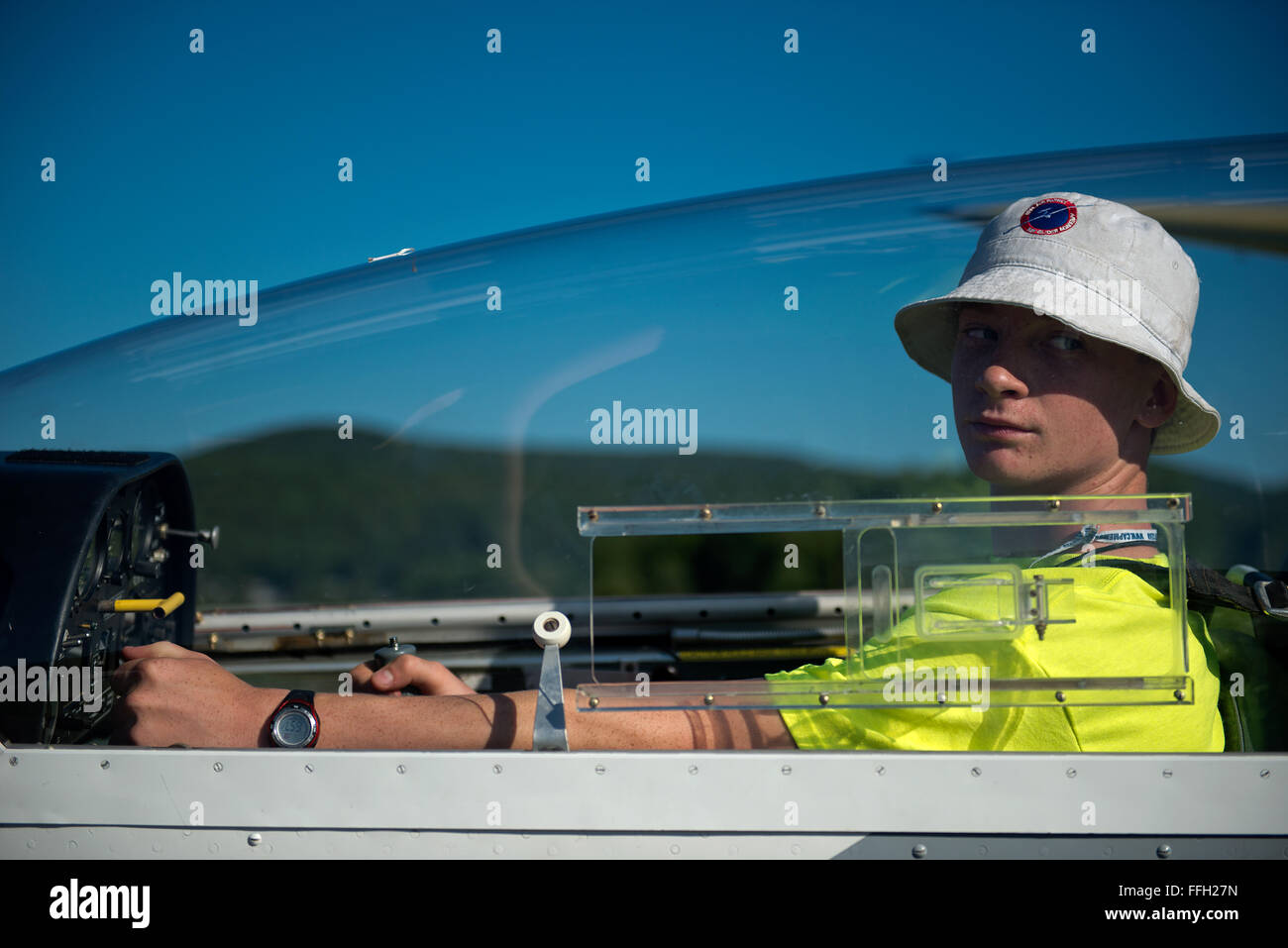 Civil Air Patrol Cadet, Jens Houck, waits for the wing-runner to signal that the air traffic pattern is clear for take-off in Springfield, Vt. Cadets attending the Northeast Region Glider Academy learn the standard hand signals used in glider ground operations. Stock Photo