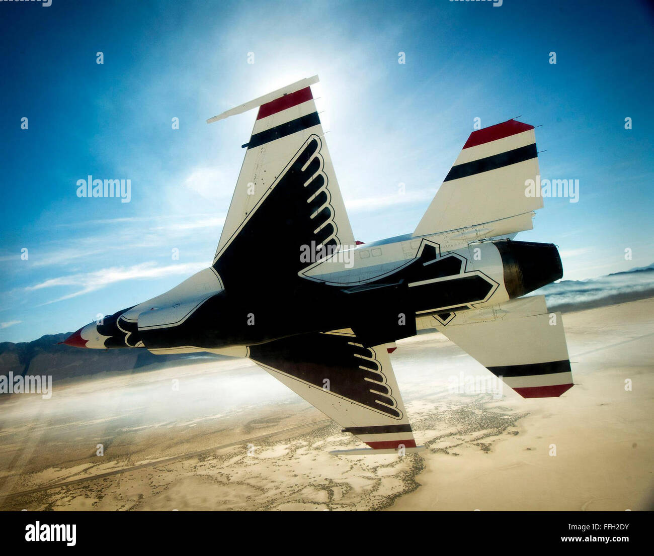 The Thunderbirds Diamond formation performs the Echelon Pass in Review maneuver March 13, 2013 during a practice sortie over a range in Nev. Stock Photo